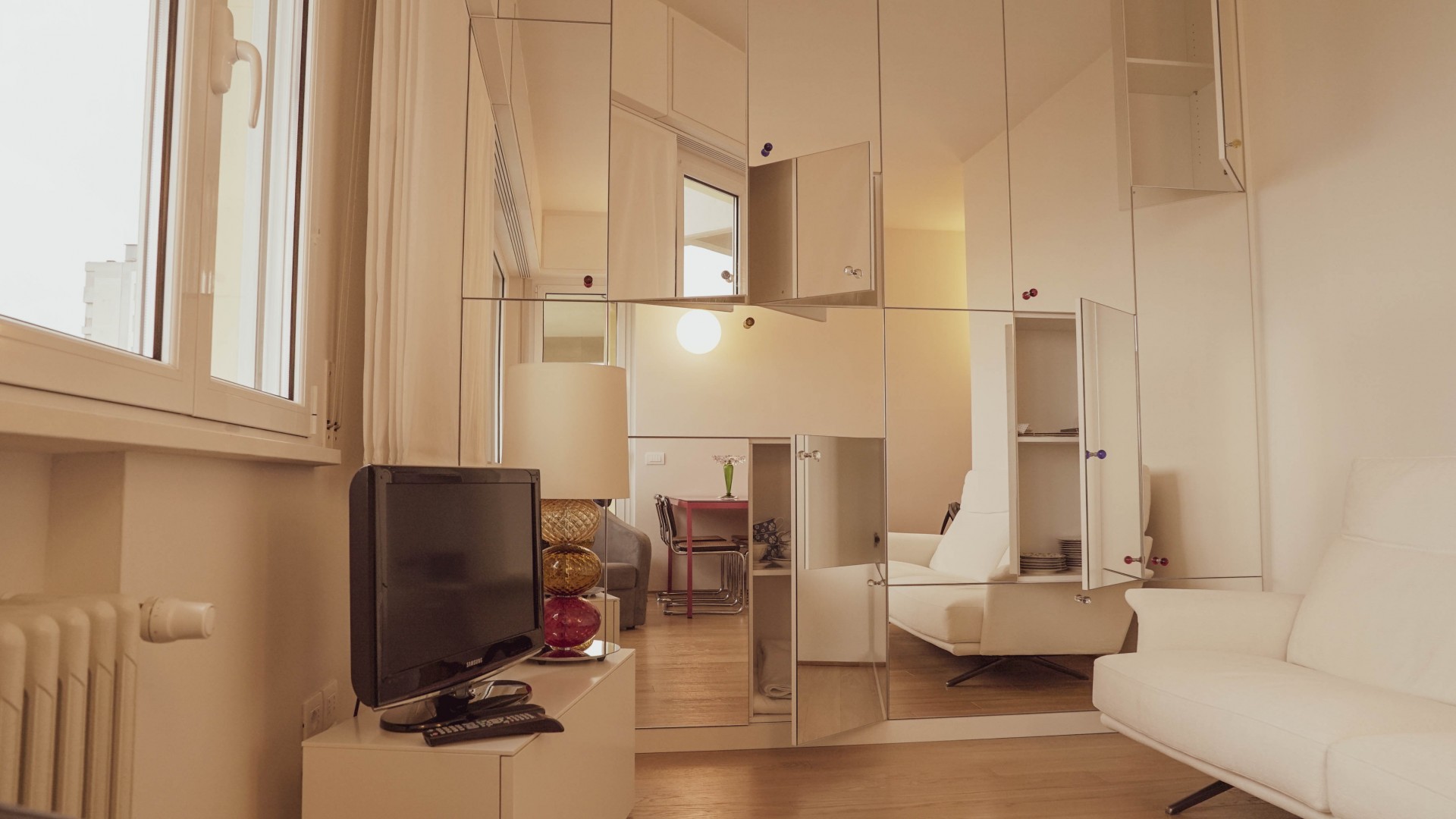 Arredamento su misura realizzato da Profili - Falegnameria & Design. Mobile con ante a specchio.